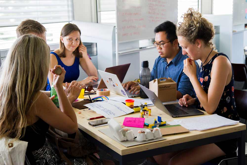 Why-Choose-Us-2 Office setting and people talking